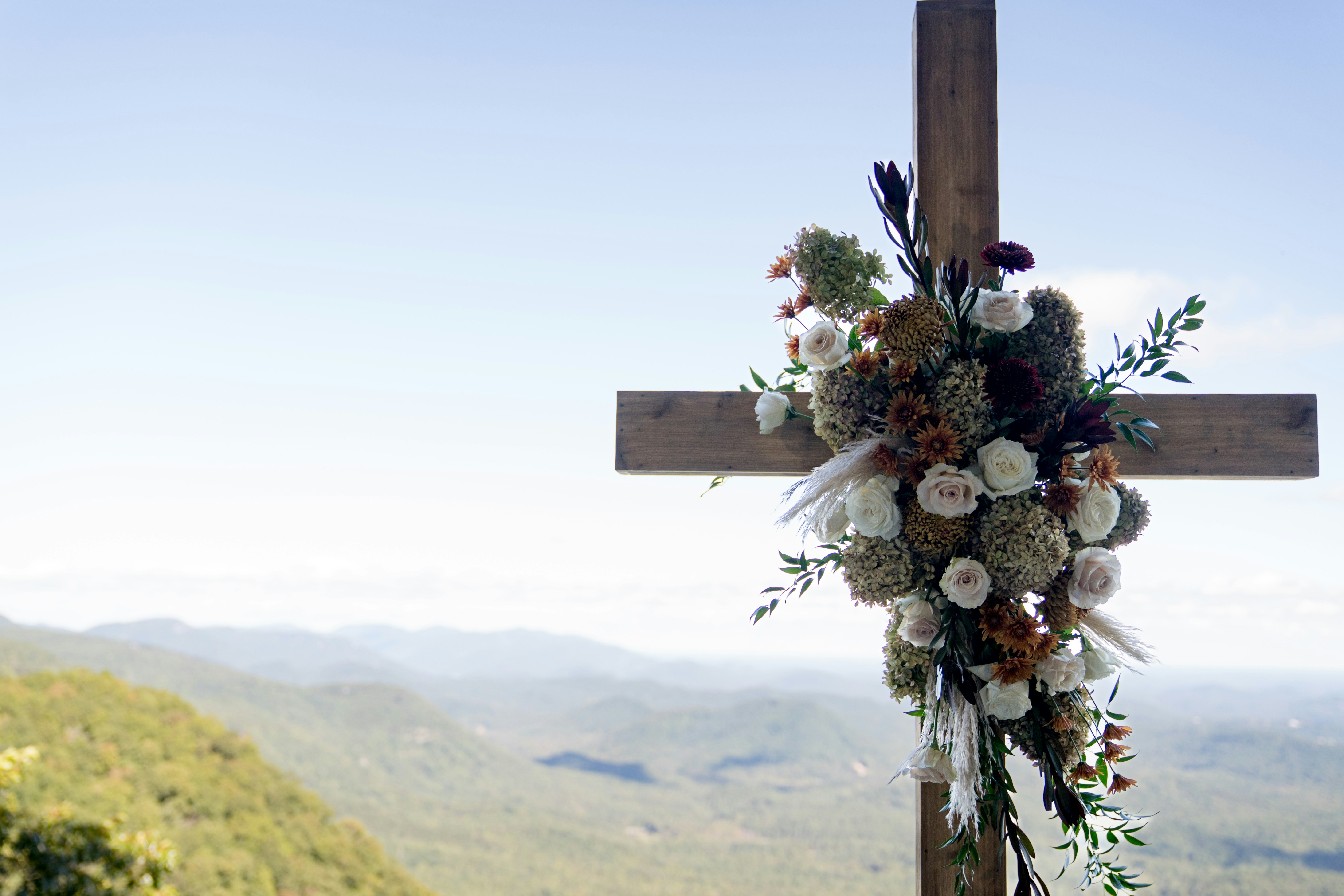 A cross Laden with flowers oversees the mountains in South Carolina.