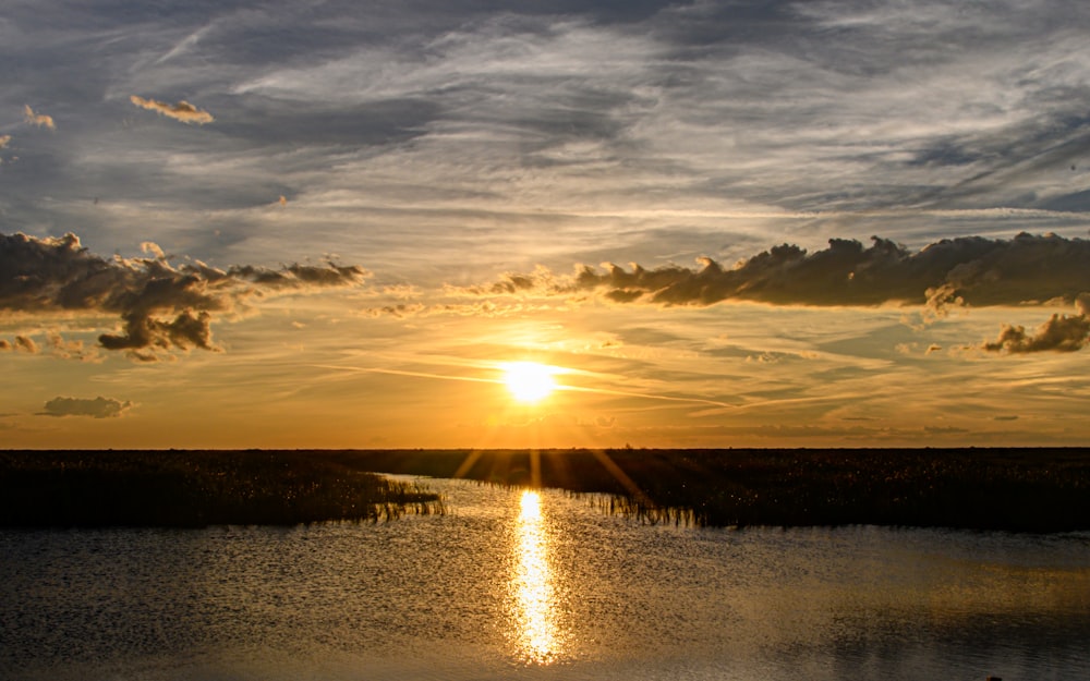 a sunset over a body of water