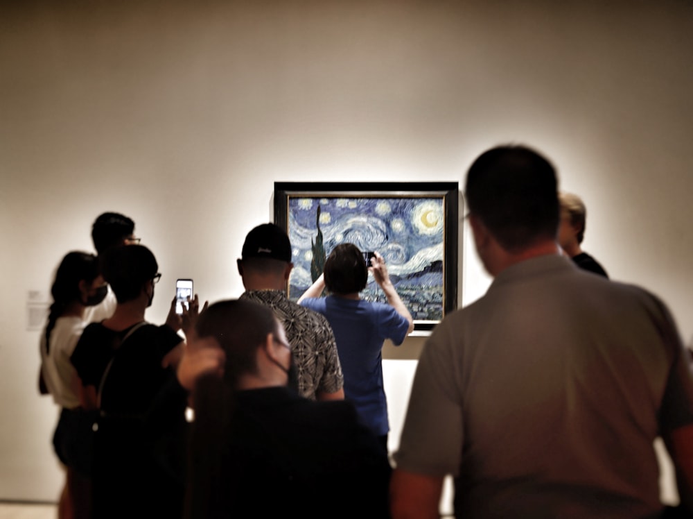 a group of people looking at a screen
