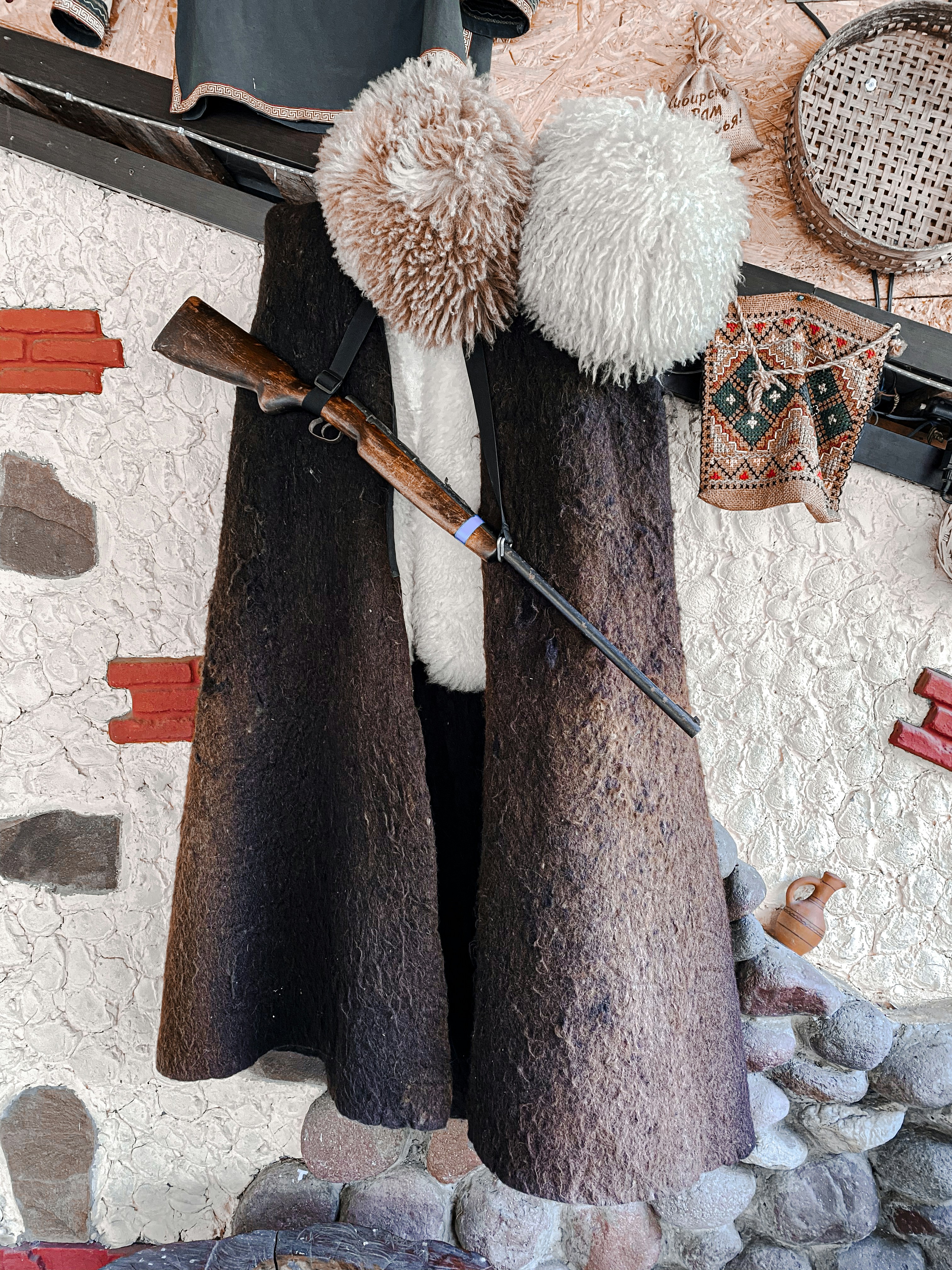 a knitted doll holding a baseball bat