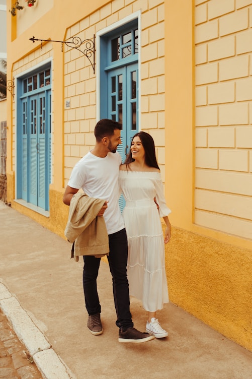 a man and woman standing next to each other and smiling