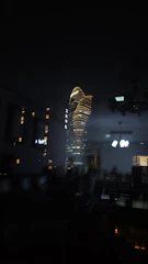 Cinematic night view from a penthouse suite overlooking city lights with subtle gold accents.