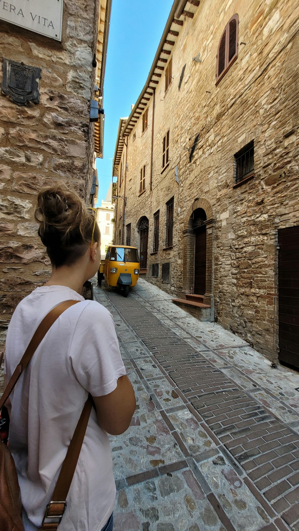 una persona che guarda un autobus su una strada