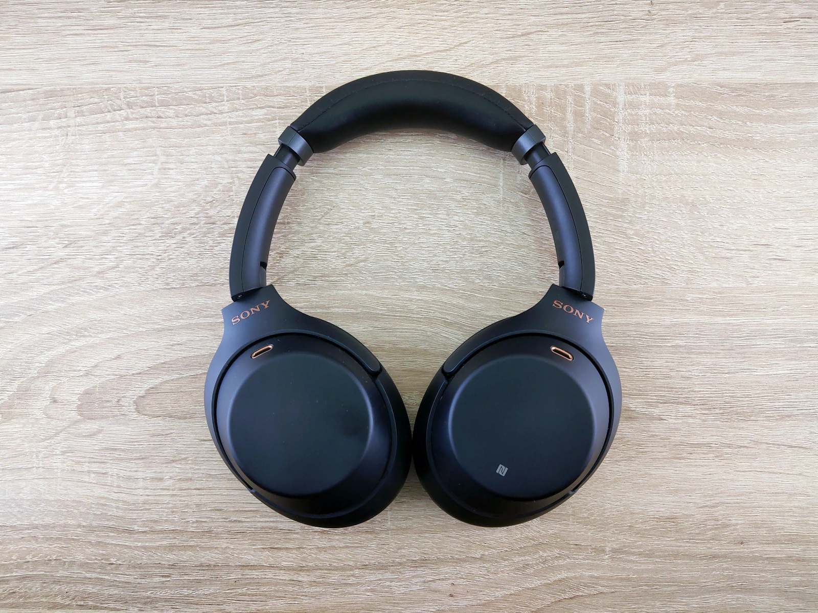 Midnight blue Sony headphones on wood