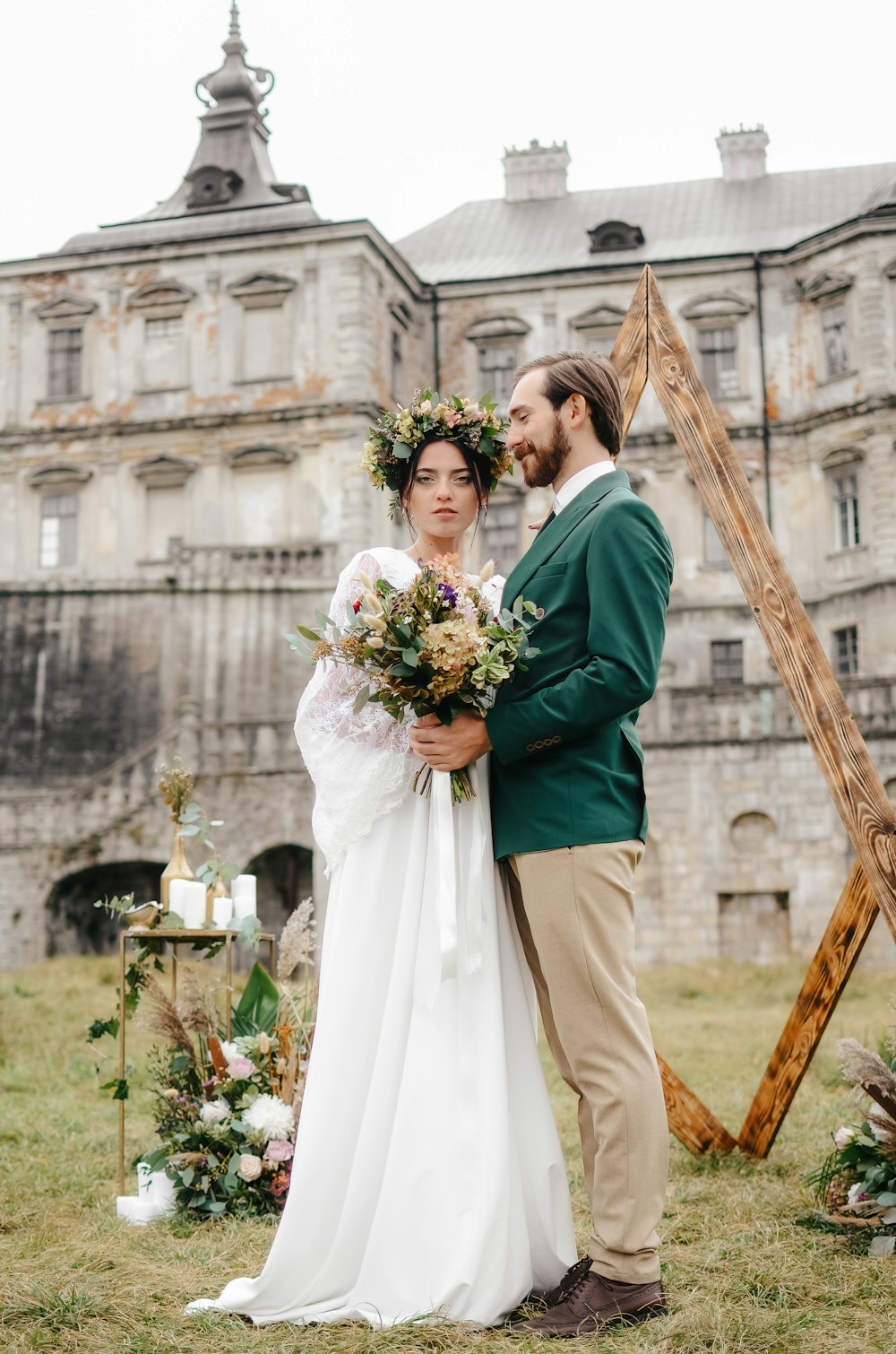 a man and woman posing for a picture in front of a building