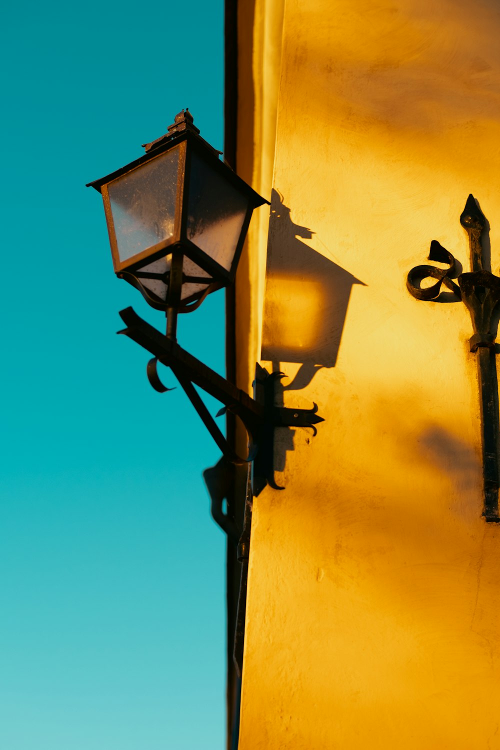 a traffic light sitting next to a lamp