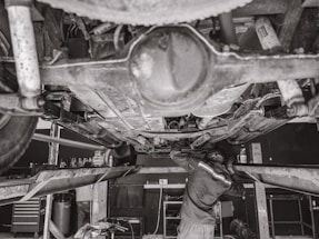 A professional mechanic working on a vehicle.