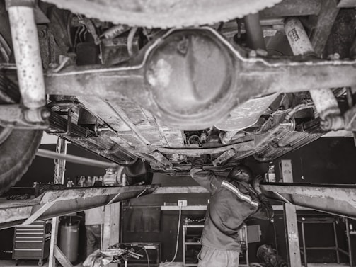 A professional mechanic working on a vehicle.