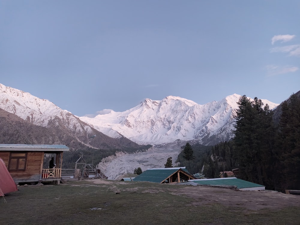 a group of buildings in front of a snowy mountain