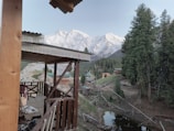 Guests enjoying morning coffee on a tiny home's porch overlooking the ranch.