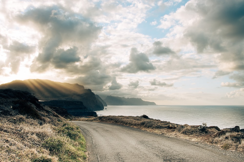 a road next to a body of water