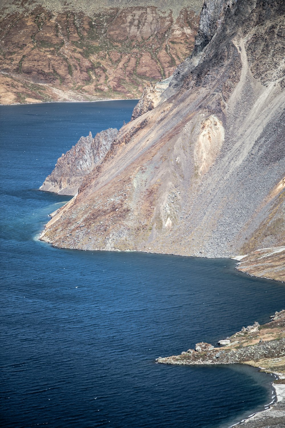 a cliff next to the water