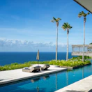 Private infinity pool overlooking the sea with comfortable loungers around.