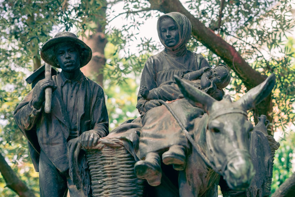 a statue of a person riding a bull