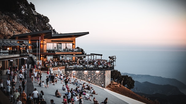 Visitors relaxing and enjoying refreshments at the outdoor seating area of the nagy-hideg-hegyi turistaház