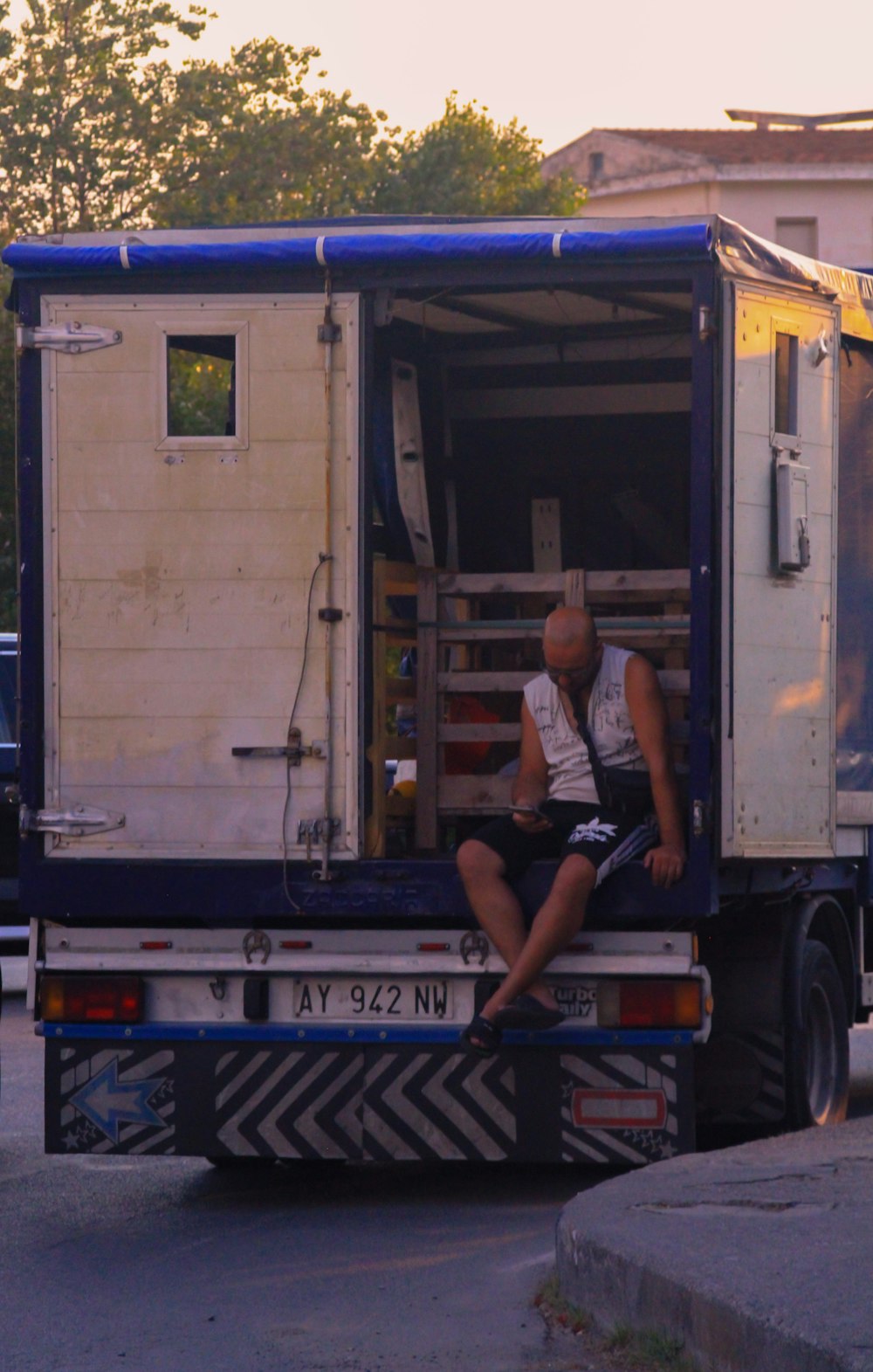 a person sitting on the back of a truck
