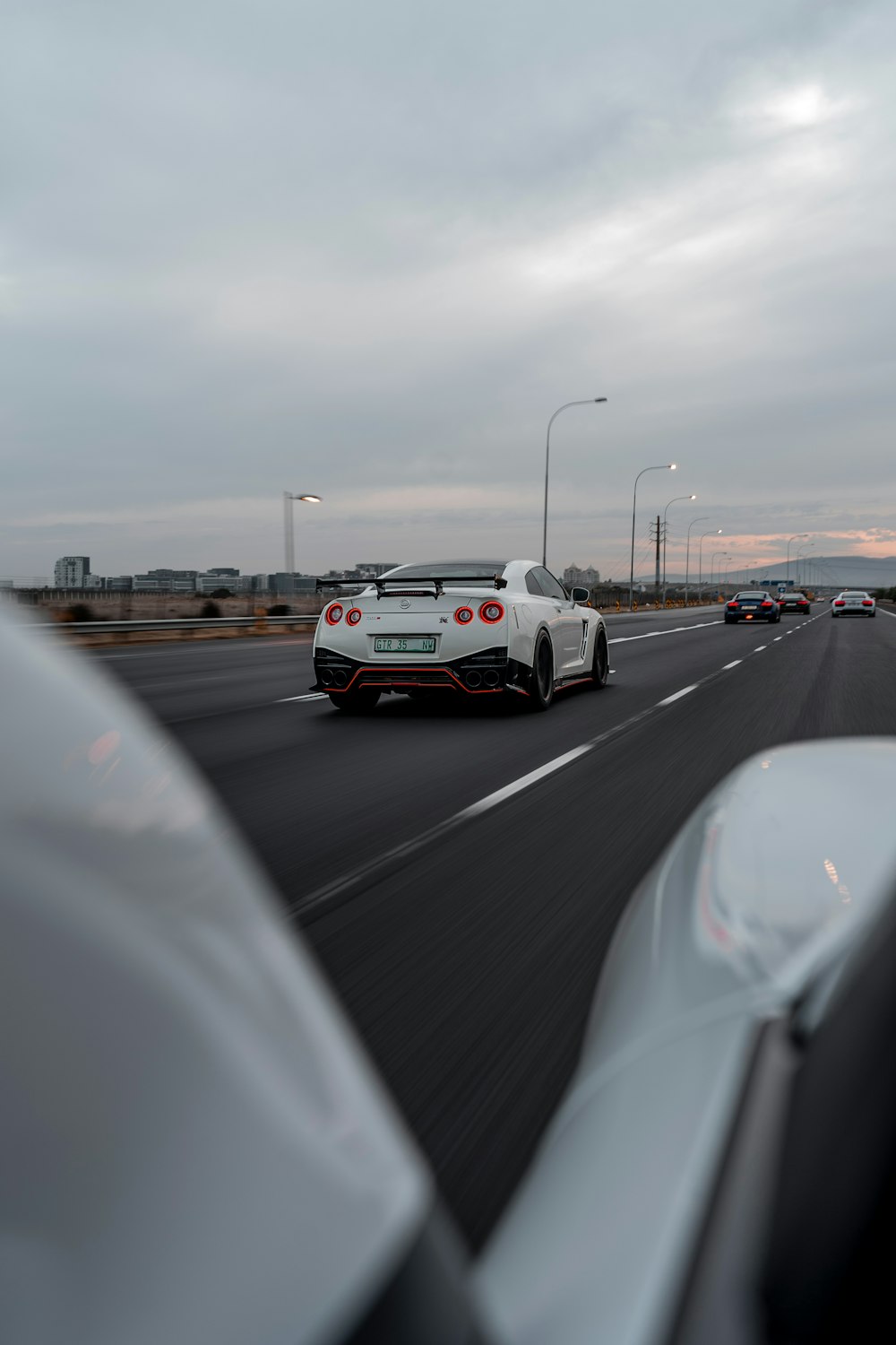 a white sports car on a road