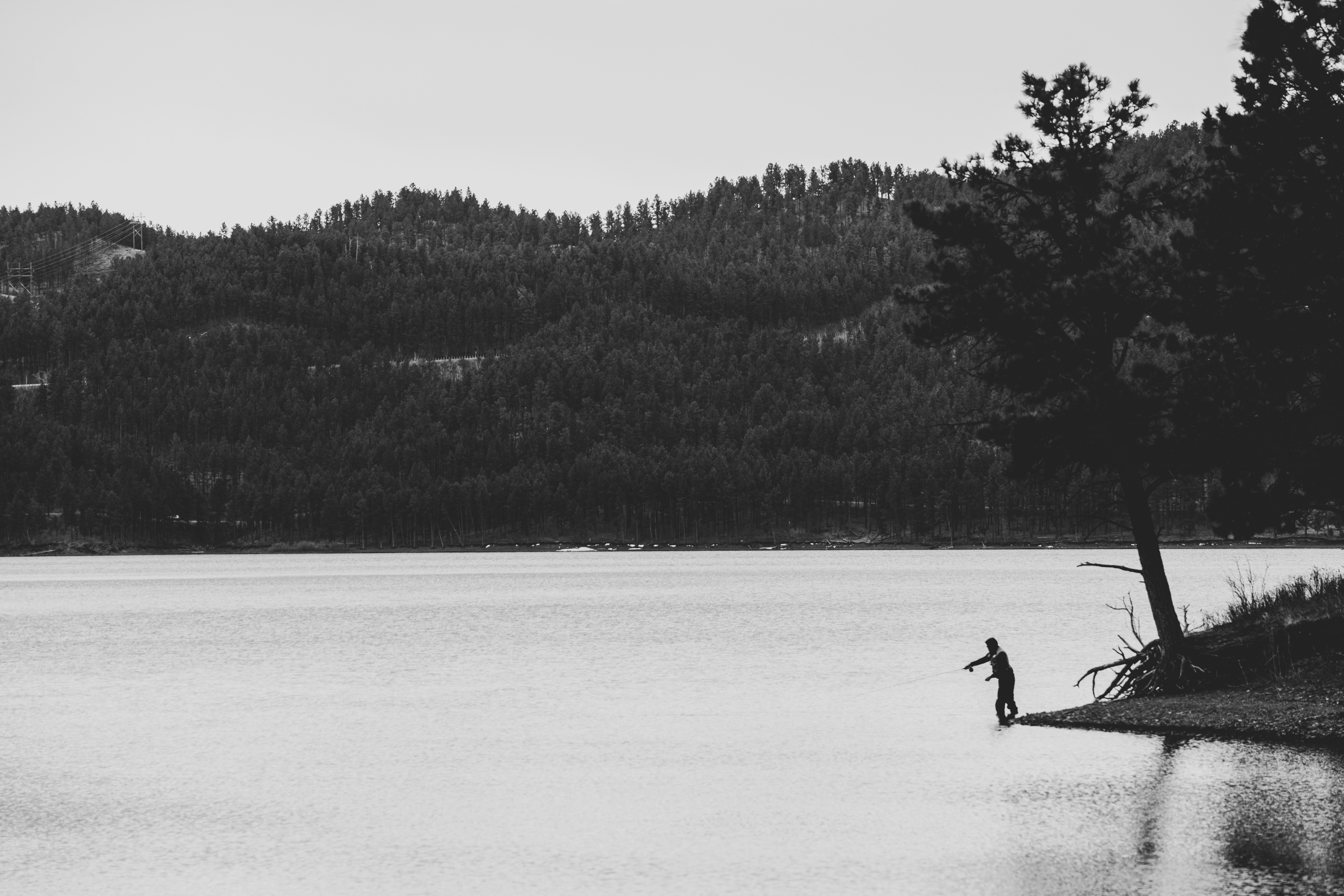 a person standing on a dock in a lake