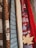 A collection of knitted sweaters in various textures and patterns, with earthy and autumnal colors. There is a maple leaf tucked into one of the sweaters, adding to the autumnal theme.