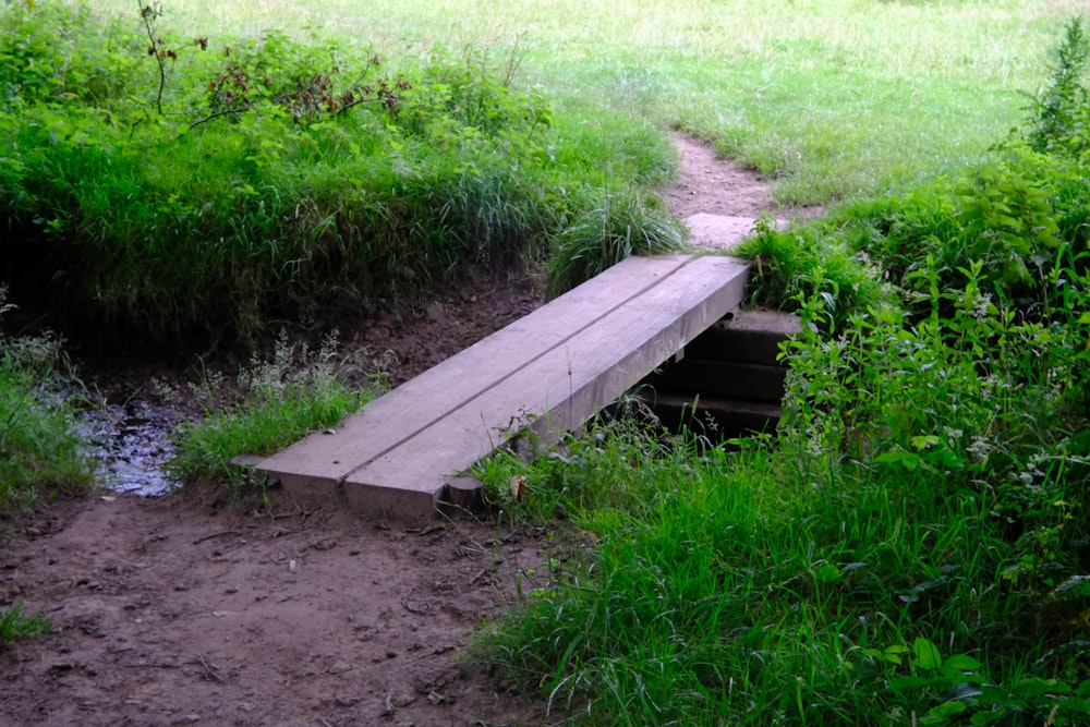 a wooden bridge over a stream