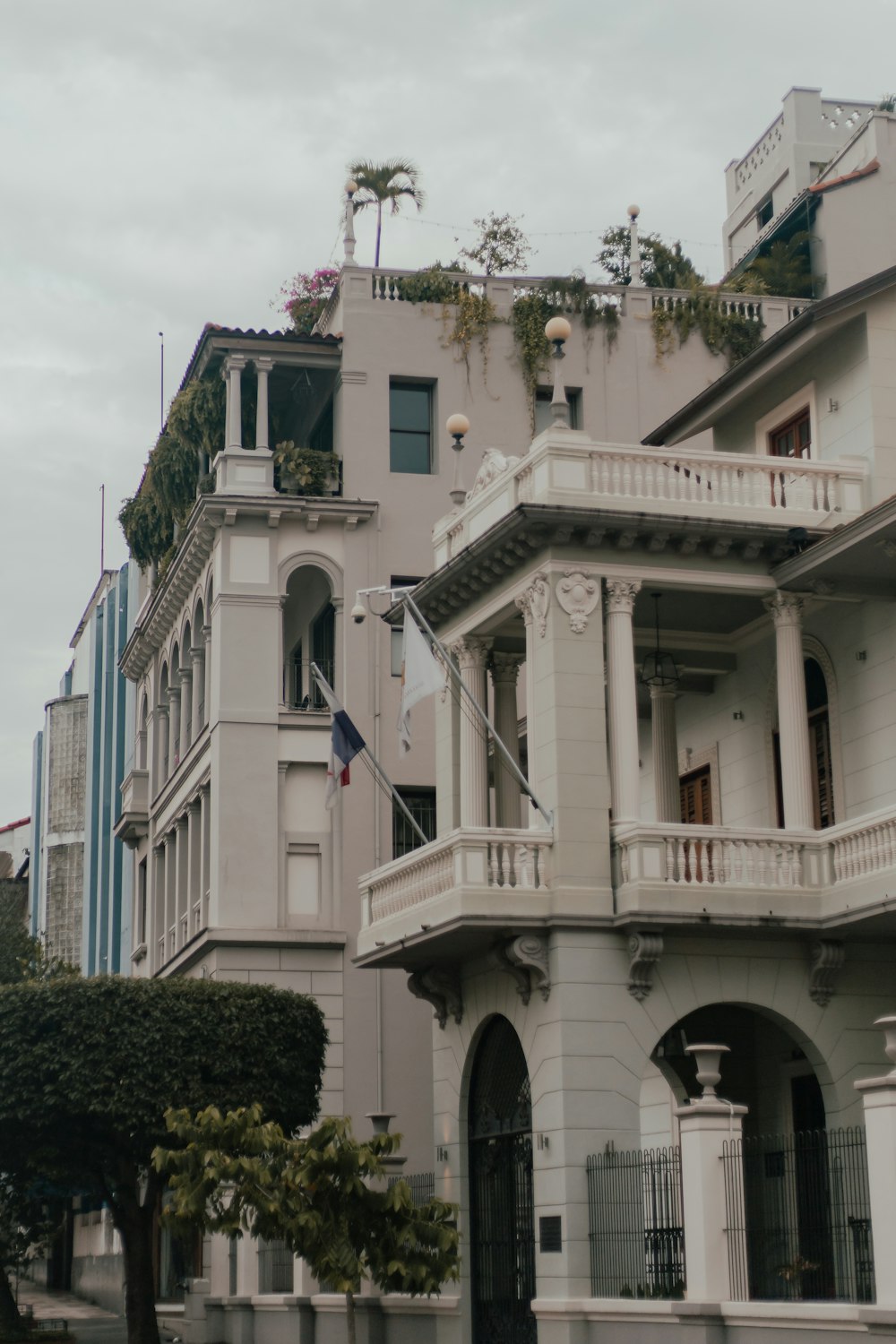 a large white building with many balconies and a flag on the roof