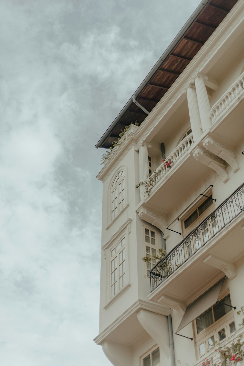 a building with balconies and a cloudy sky