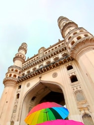 a couple of umbrellas in front of a large building