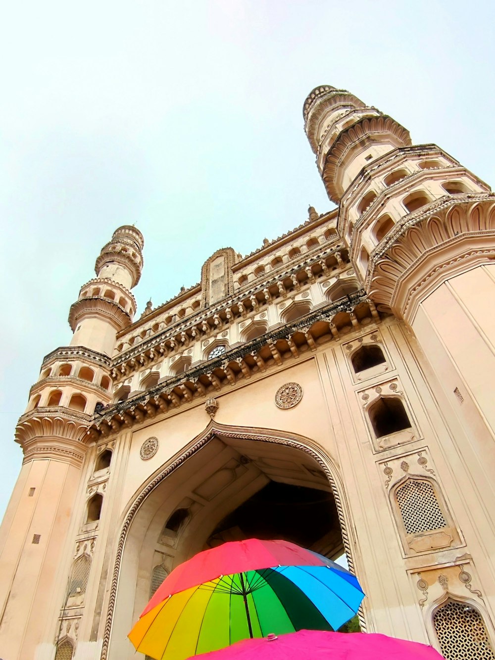 a couple of umbrellas in front of a large building