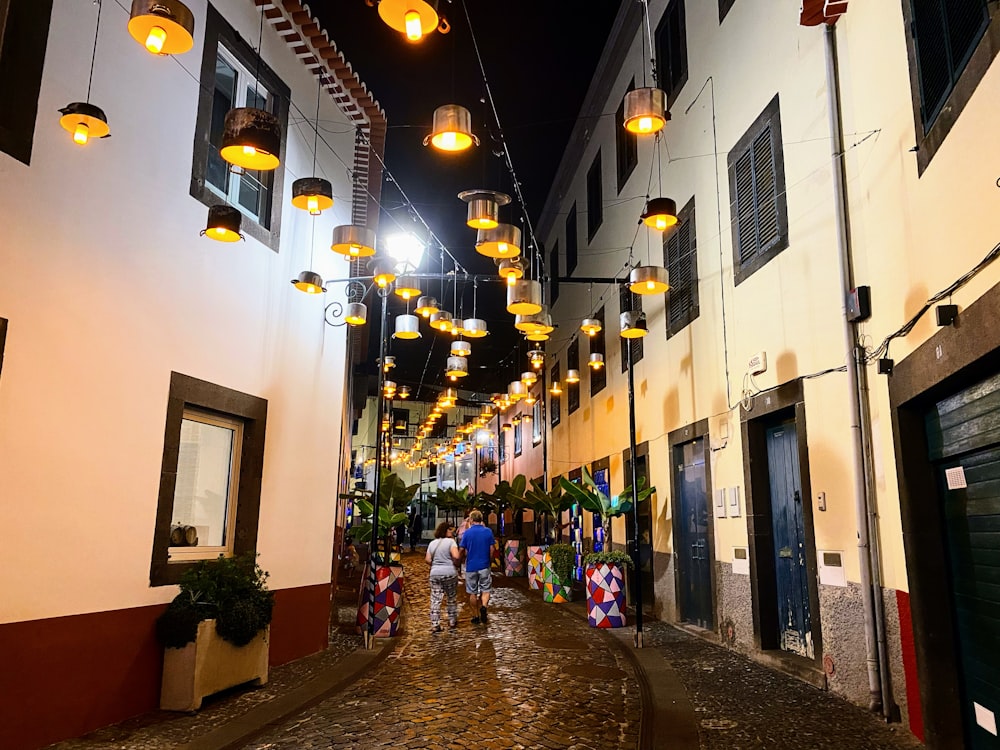 people walking down a narrow street