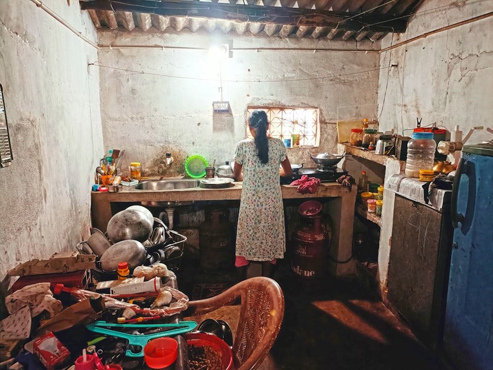 a woman standing in a dirty room