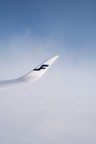 An airplane taking off under a clear blue sky with Sky Bridge Aviation logo visible.