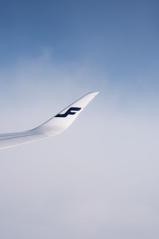 An airplane taking off under a clear blue sky with Sky Bridge Aviation logo visible.