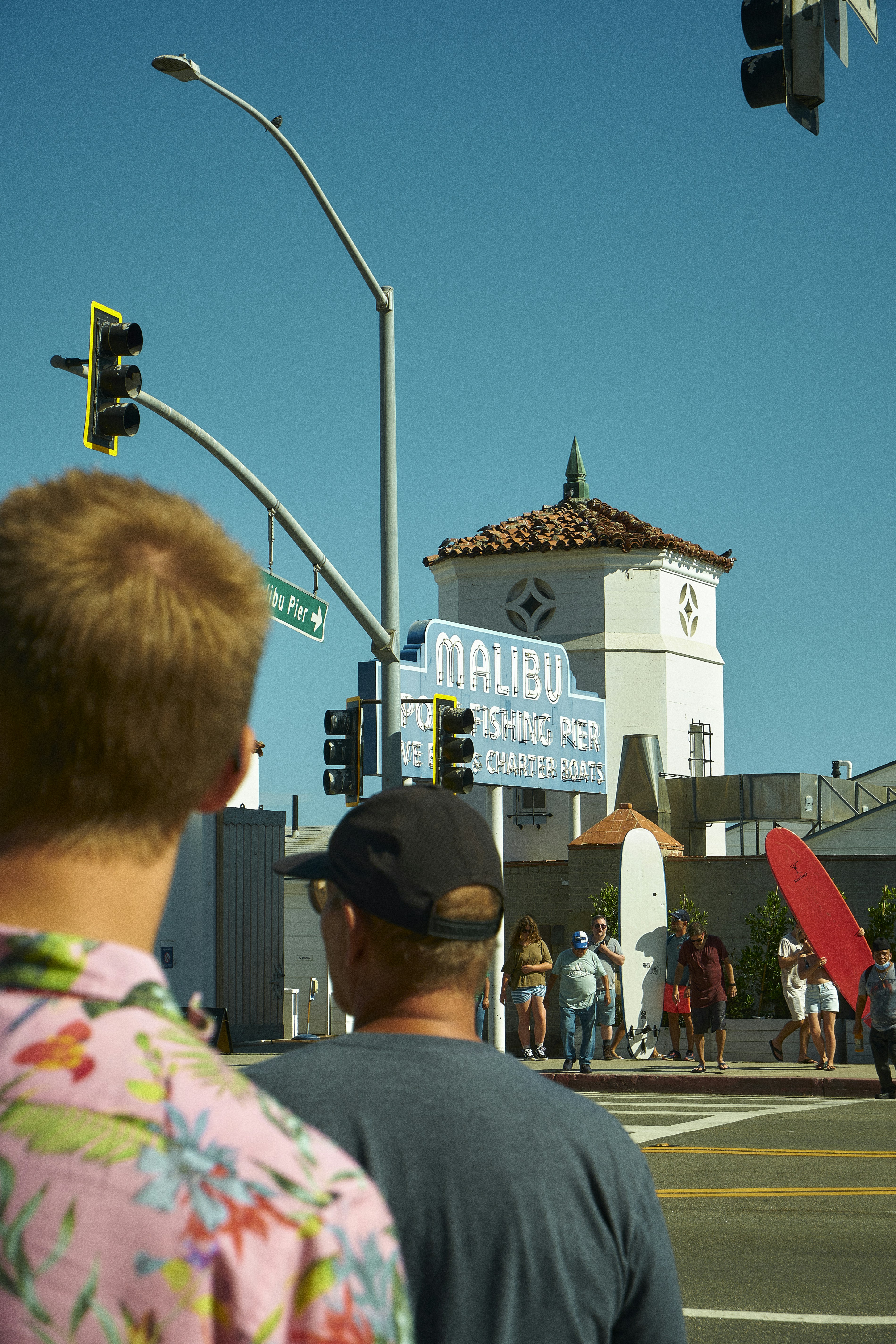 people waiting at a traffic light