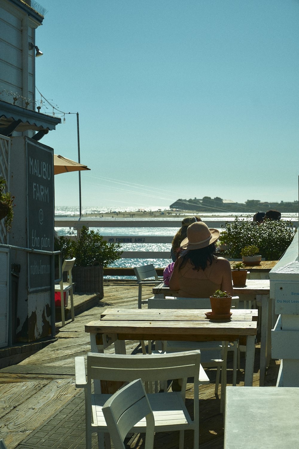 a person sitting at a table outside