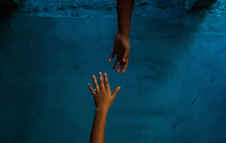 a pair of hands on a blue surface