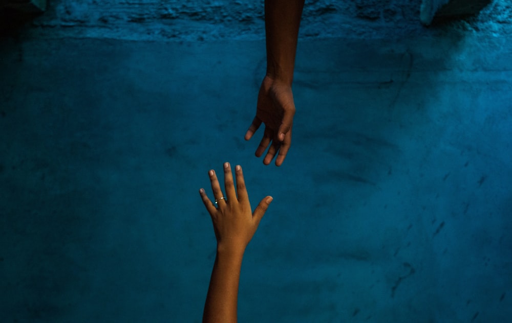 a pair of hands on a blue surface