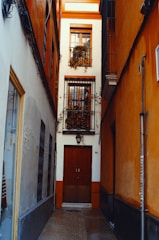 a narrow alley way with a door and a window