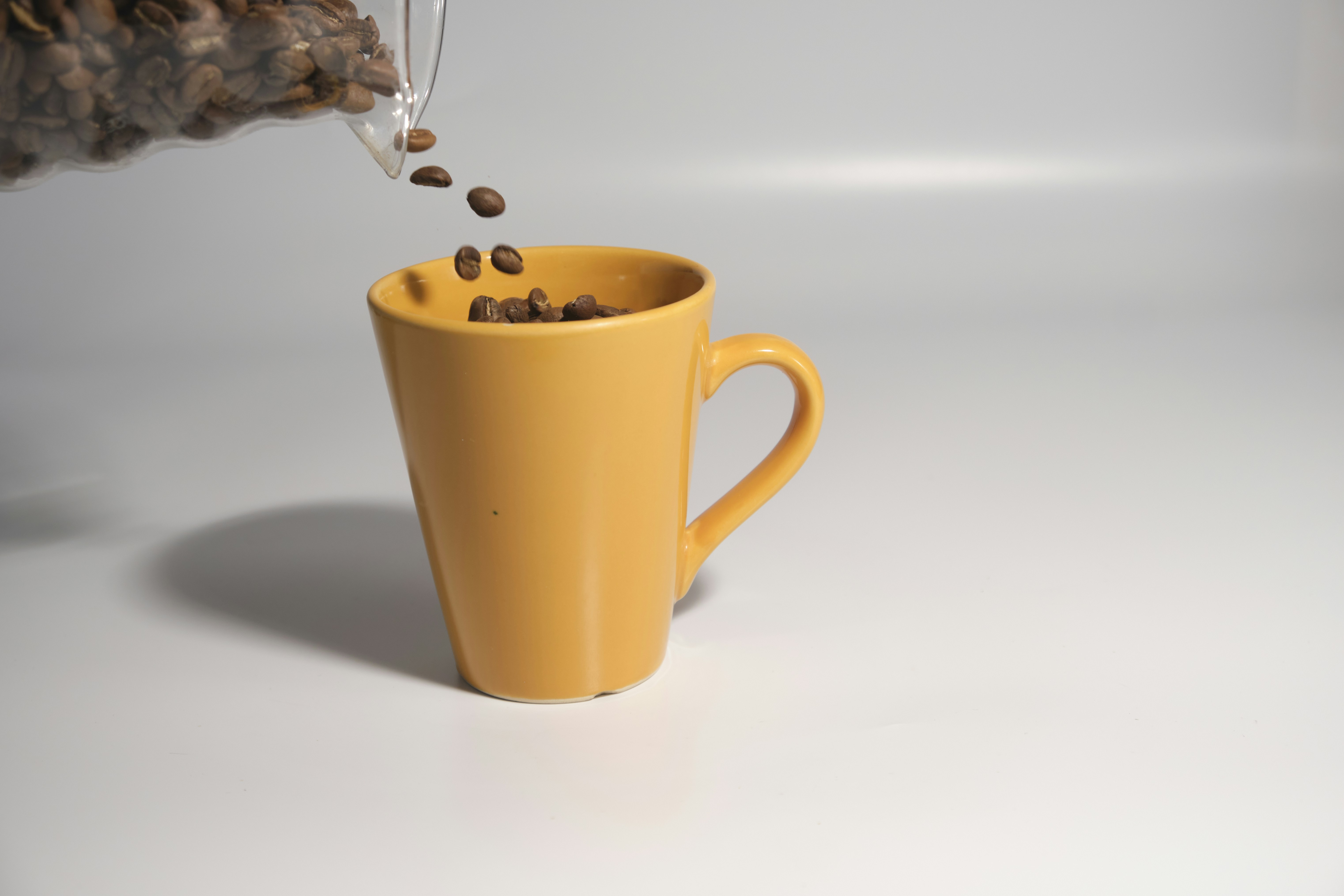 a yellow cup with a handle