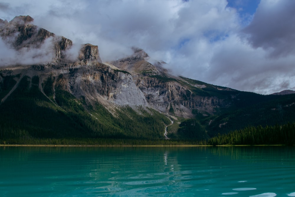 a body of water with mountains in the background