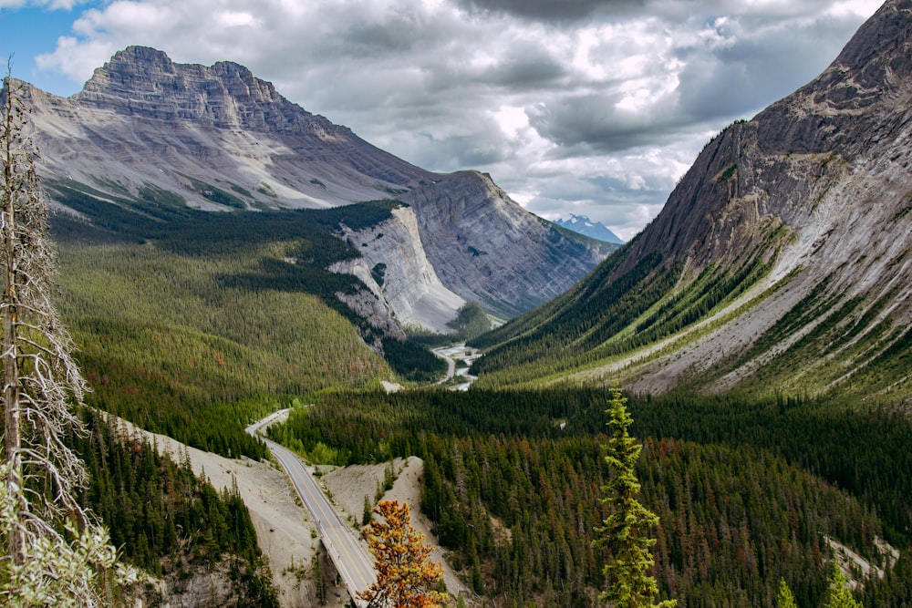 a road in a valley between mountains