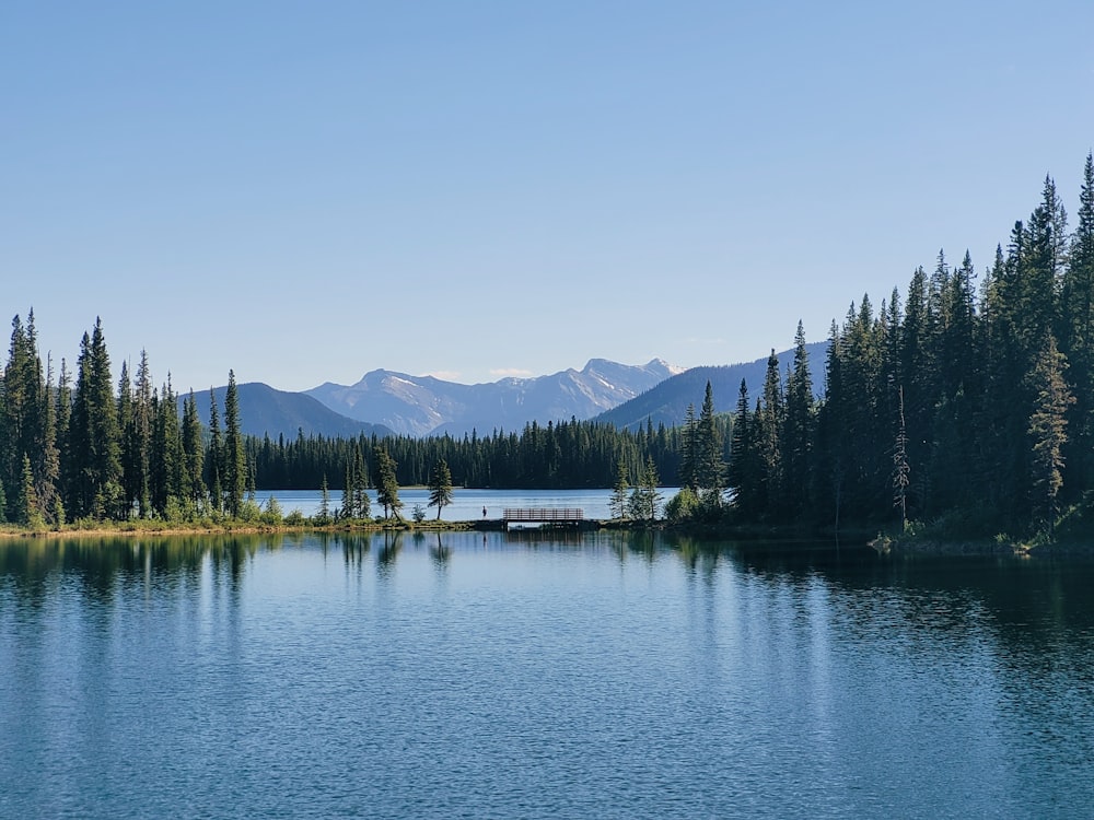 Lac Beauvert with trees and mountains in the background