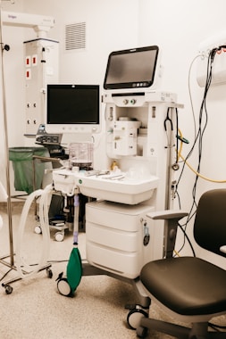 a room with a computer and medical equipment