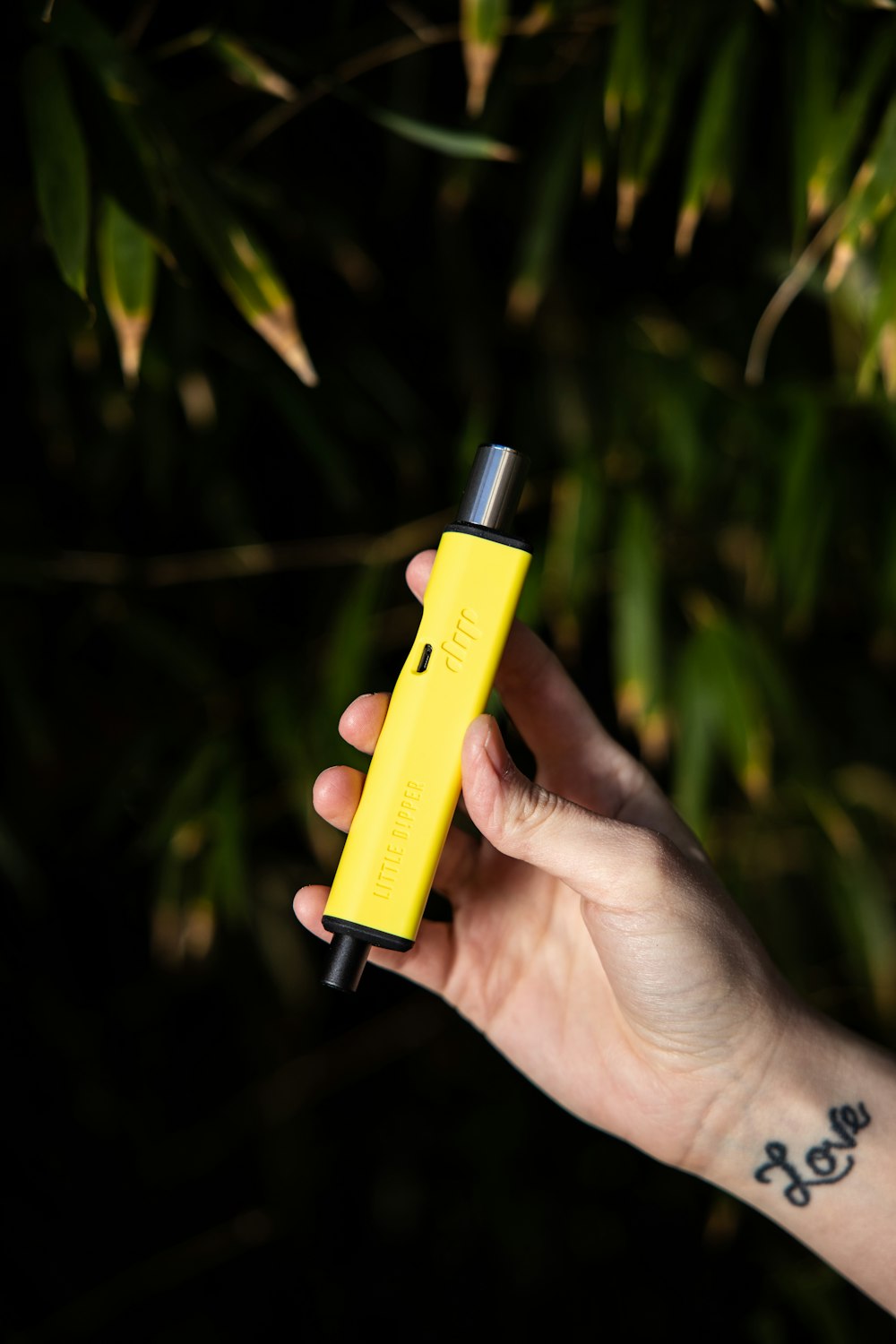 a person holding a yellow measuring device