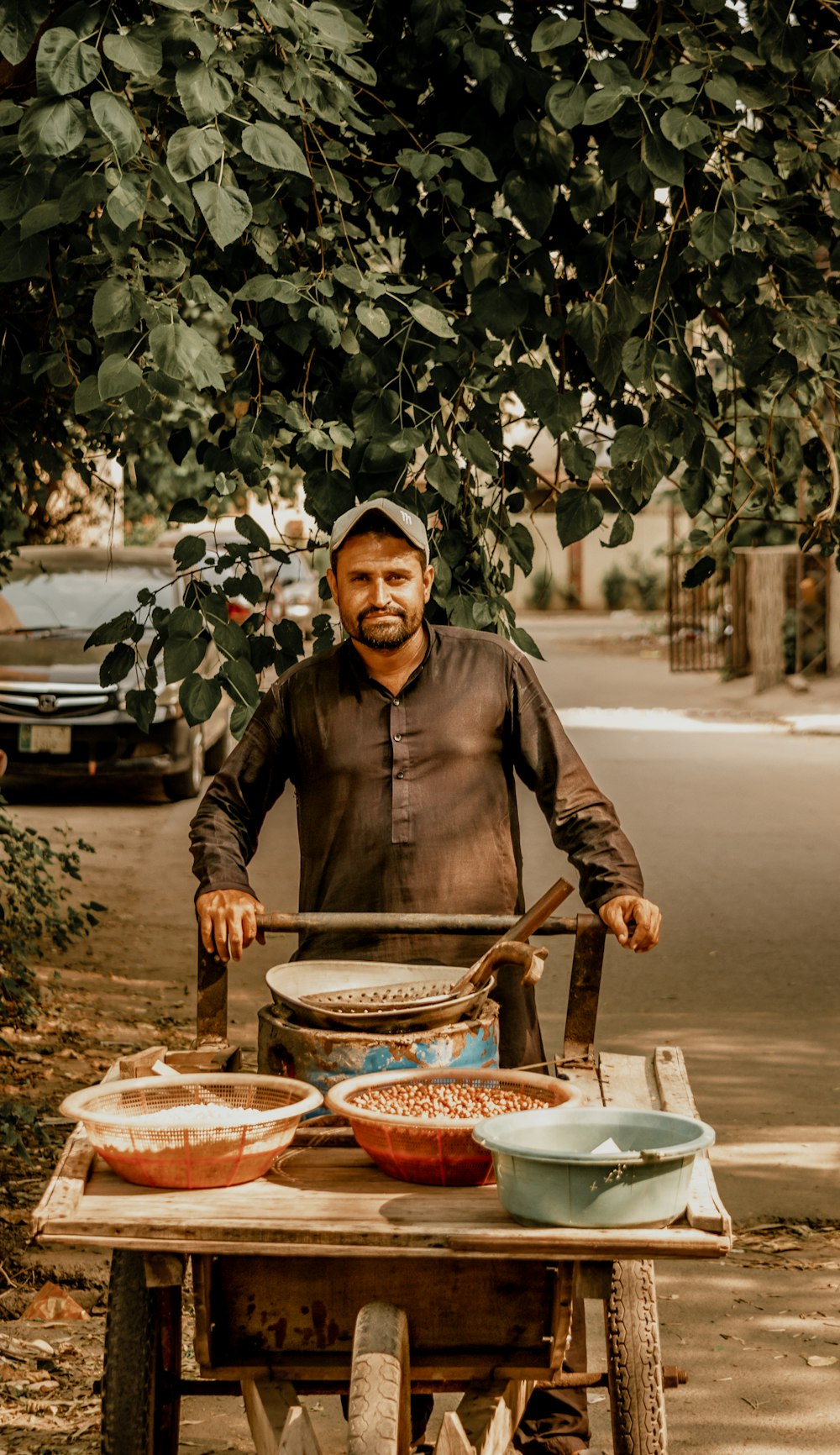 a person sitting on a cart with bowls of food