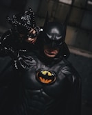 Batman suit with dark cape, detailed mask, and symbol on chest.