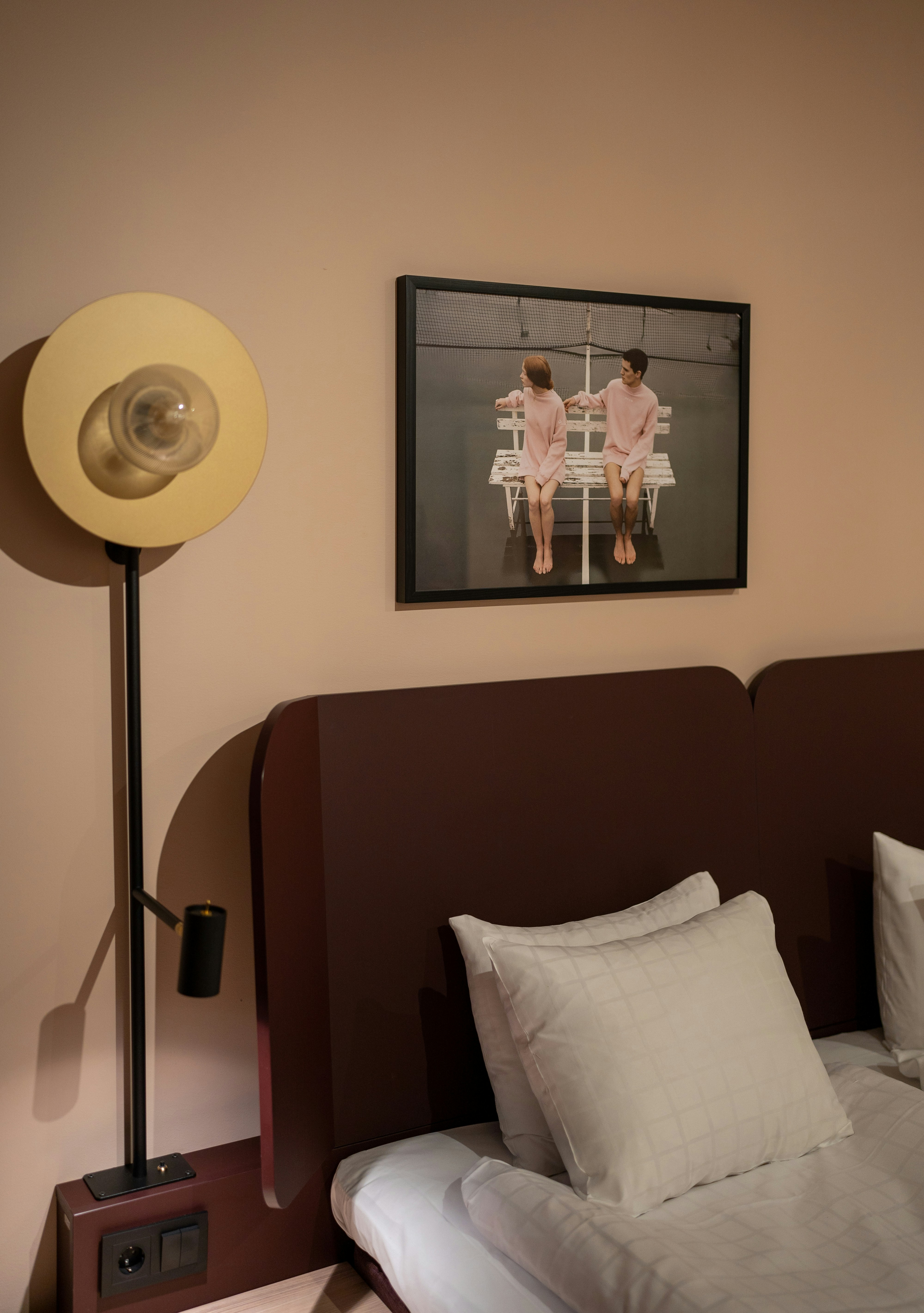 a lamp next to a bed