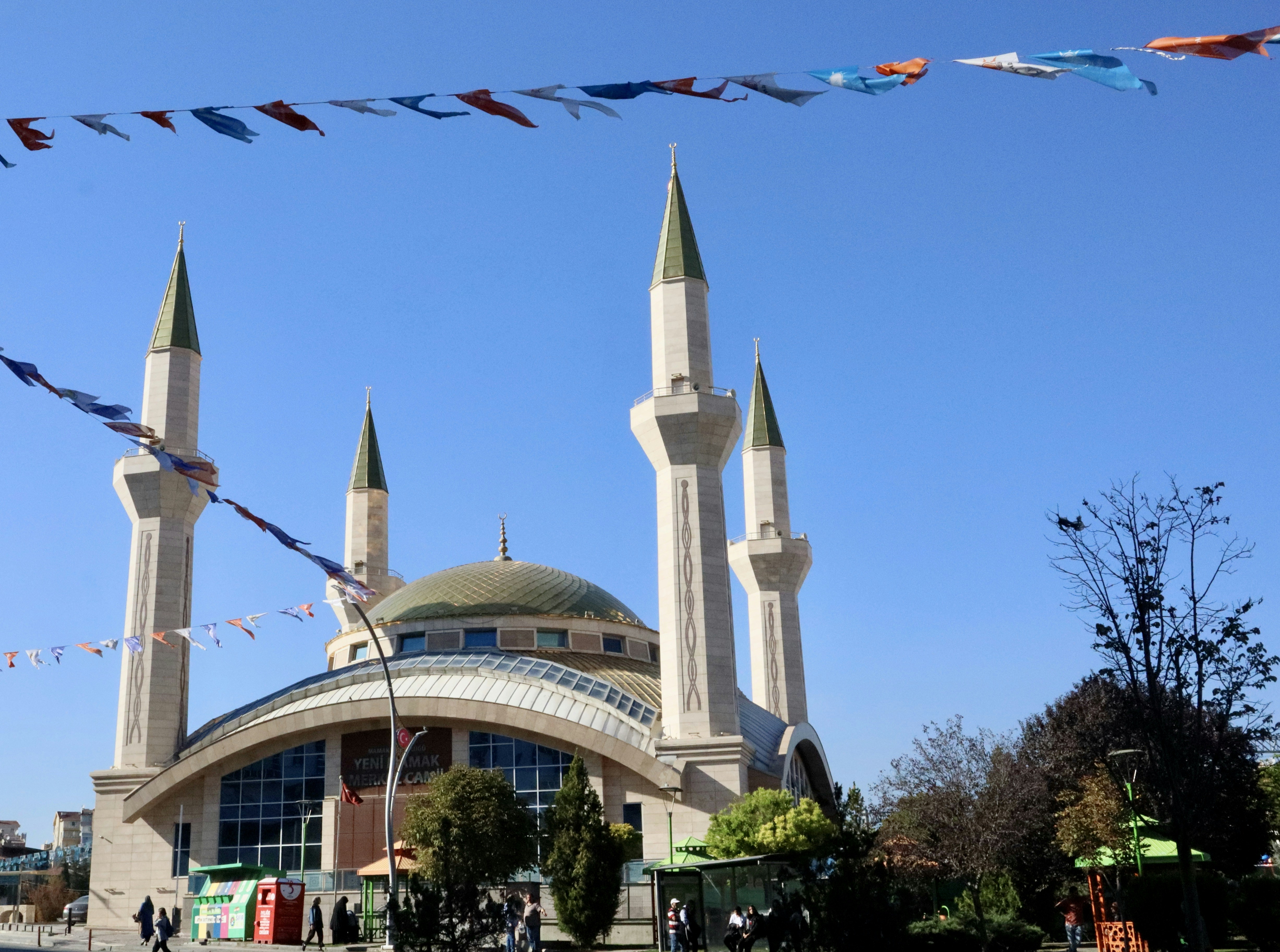 a building with a tower and kites flying in the air