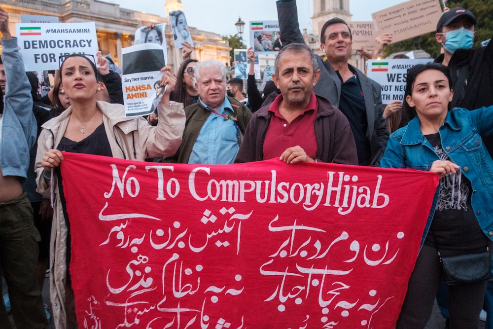 a group of people holding signs