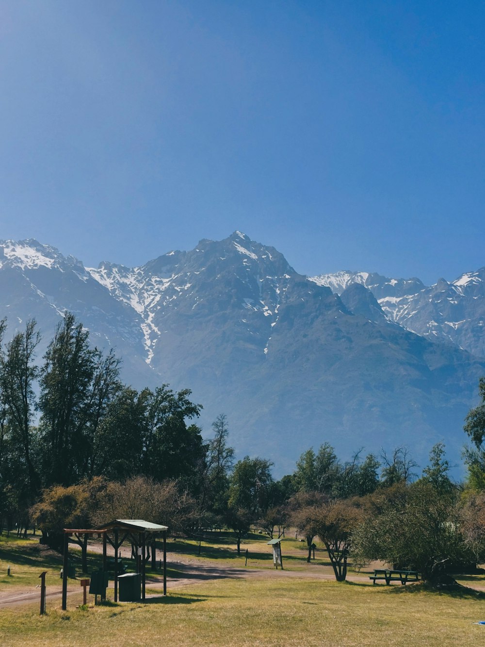 a mountain range with trees and a picnic table