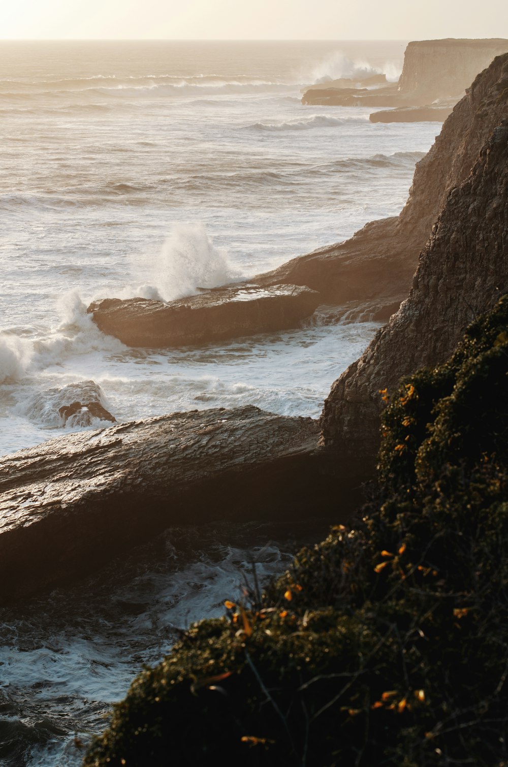 a rocky beach with waves crashing against it